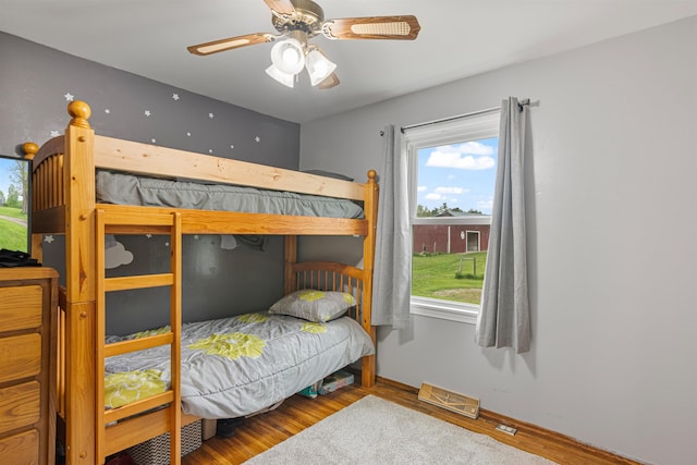 870 Cheesefactory Rd, Shelburne, VT 05482 - bedroom with wood finished floors, multiple windows, baseboards, and ceiling fan