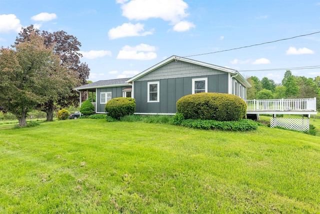 870 Cheesefactory Rd, Shelburne, VT 05482 - back of house with board and batten siding, a lawn, and a wooden deck