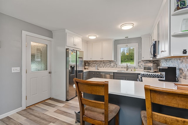 870 Cheesefactory Rd, Shelburne, VT 05482 - kitchen featuring appliances with stainless steel finishes, a sink, light wood-style floors, and backsplash