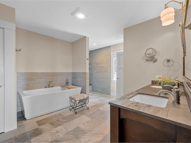 344 Morrie Rd, Washington, VT 05675 - bathroom featuring double vanity, tile walls, a freestanding bath, and a walk in shower