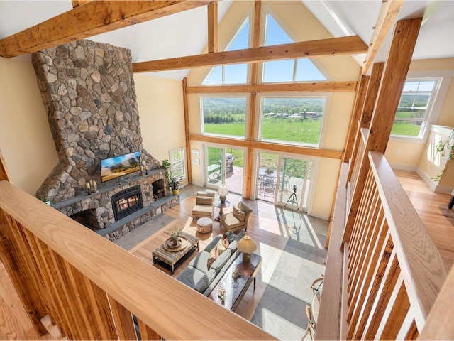 344 Morrie Rd, Washington, VT 05675 - living room with high vaulted ceiling, a stone fireplace, beamed ceiling, and wood finished floors