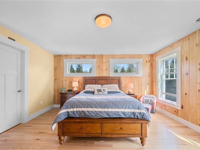344 Morrie Rd, Washington, VT 05675 - bedroom featuring baseboards, light wood finished floors, multiple windows, and wooden walls