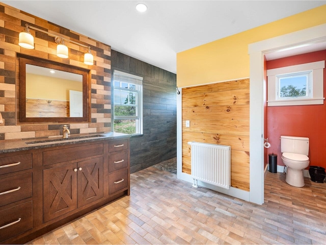 344 Morrie Rd, Washington, VT 05675 - full bath with radiator heating unit, vanity, wood walls, toilet, and recessed lighting