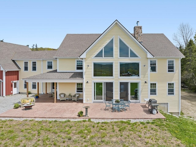 344 Morrie Rd, Washington, VT 05675 - back of property featuring a chimney, an outdoor hangout area, a patio area, and a shingled roof
