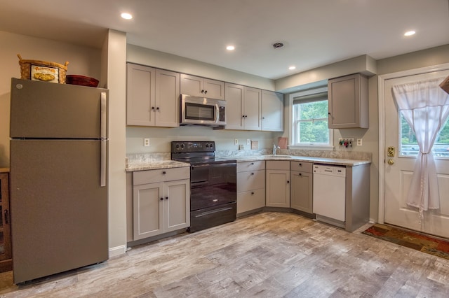 78 Saco Pines Rd Unit 9, Conway, NH 03813 - kitchen with freestanding refrigerator, black range with electric stovetop, white dishwasher, stainless steel microwave, and gray cabinets