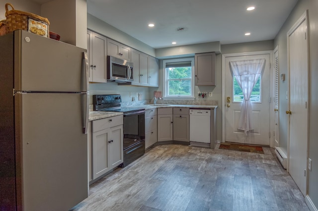 78 Saco Pines Rd Unit 9, Conway, NH 03813 - kitchen featuring freestanding refrigerator, black range with electric stovetop, stainless steel microwave, white dishwasher, and light wood-style floors