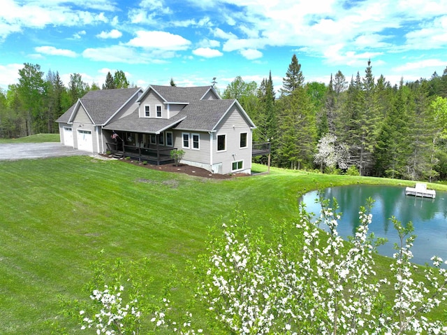 51 Lake View Rd, Westmore, VT 05822 - view of front of property featuring asphalt driveway, an attached garage, a front lawn, and a water view
