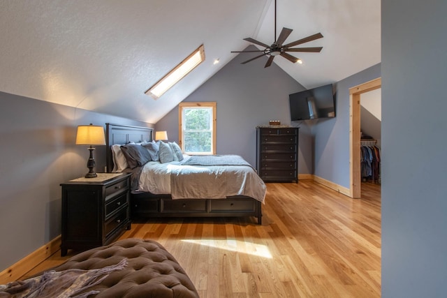 51 Lake View Rd, Westmore, VT 05822 - bedroom featuring a skylight, baseboards, light wood finished floors, vaulted ceiling, and a ceiling fan