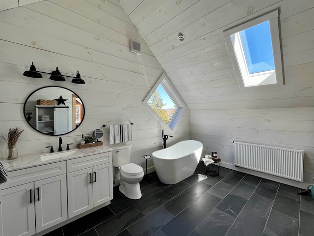 51 Lake View Rd, Westmore, VT 05822 - bathroom featuring radiator heating unit, a skylight, wood walls, a freestanding tub, and vanity