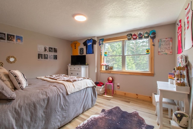 51 Lake View Rd, Westmore, VT 05822 - bedroom featuring light wood-style floors, baseboards, and a textured ceiling