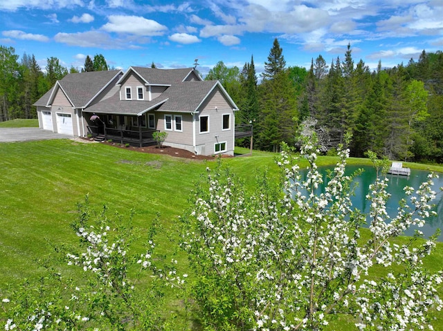 51 Lake View Rd, Westmore, VT 05822 - view of side of home featuring a garage, driveway, a yard, covered porch, and a water view