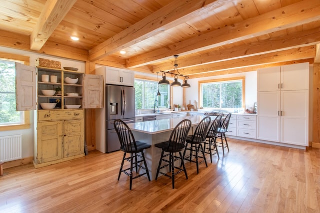 51 Lake View Rd, Westmore, VT 05822 - dining area featuring radiator, light wood finished floors, healthy amount of natural light, and wood ceiling with exposed beams