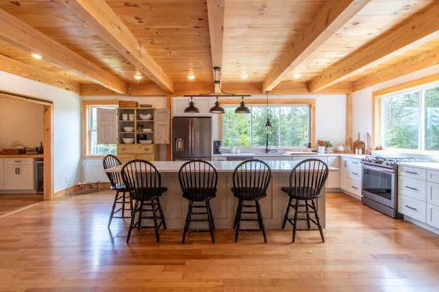 51 Lake View Rd, Westmore, VT 05822 - kitchen featuring stainless steel appliances, light wood-style floors, white cabinets, a kitchen island, and wooden ceiling with exposed beams
