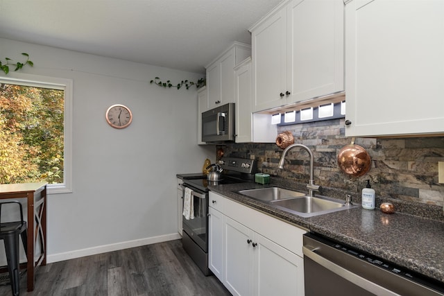 71 Scottsdale Rd, Newport City, VT 05855 - kitchen featuring stainless steel appliances, a sink, decorative backsplash, dark wood-style floors, and white cabinetry