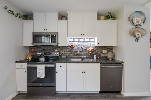 71 Scottsdale Rd, Newport City, VT 05855 - kitchen with appliances with stainless steel finishes, a sink, dark countertops, white cabinets, and dark wood-type flooring