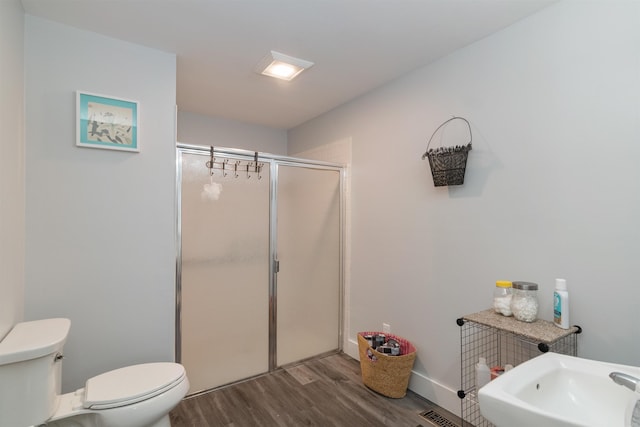 71 Scottsdale Rd, Newport City, VT 05855 - bathroom featuring toilet, wood finished floors, a stall shower, and a sink