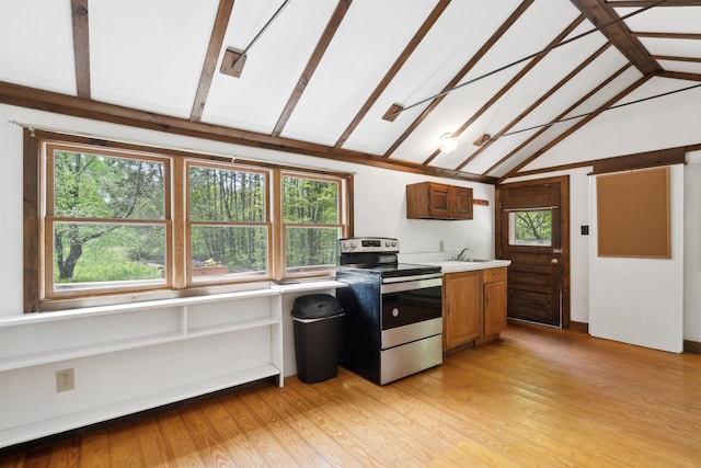 1176 Cross Rd, Strafford, VT 05070 - kitchen with stainless steel electric stove, a sink, lofted ceiling, light countertops, and healthy amount of natural light