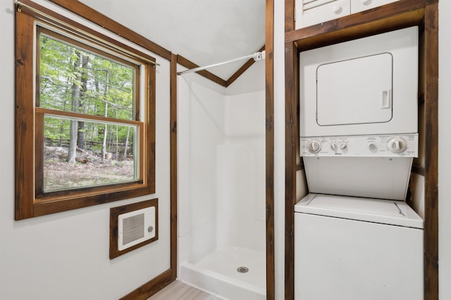 1176 Cross Rd, Strafford, VT 05070 - full bath featuring stacked washer and clothes dryer, a stall shower, heating unit, and baseboards