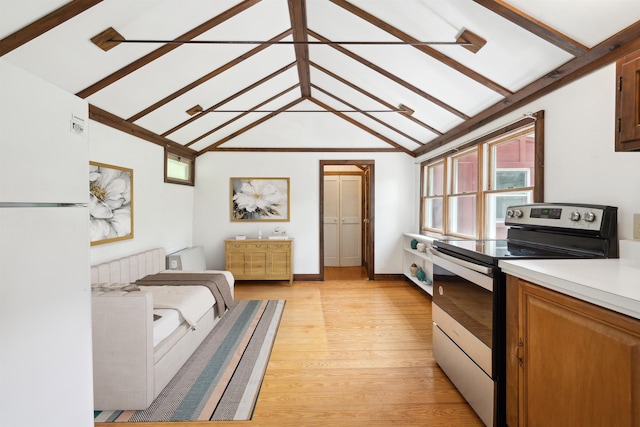 1176 Cross Rd, Strafford, VT 05070 - kitchen featuring stainless steel range with electric stovetop, light wood-type flooring, light countertops, freestanding refrigerator, and baseboards