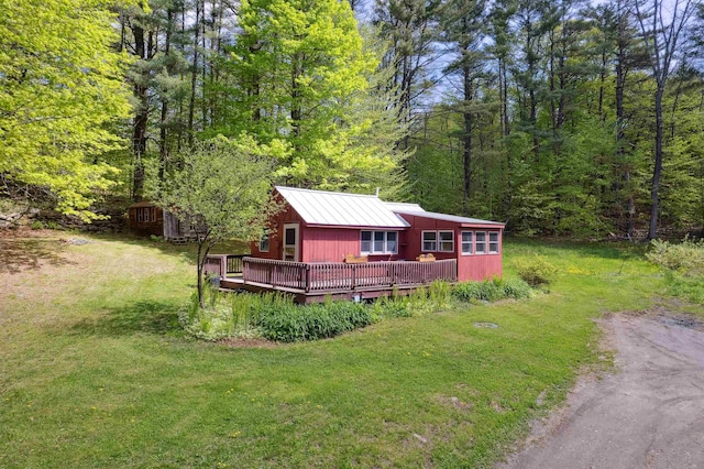 1176 Cross Rd, Strafford, VT 05070 - view of front of home featuring a deck, a wooded view, and a front lawn