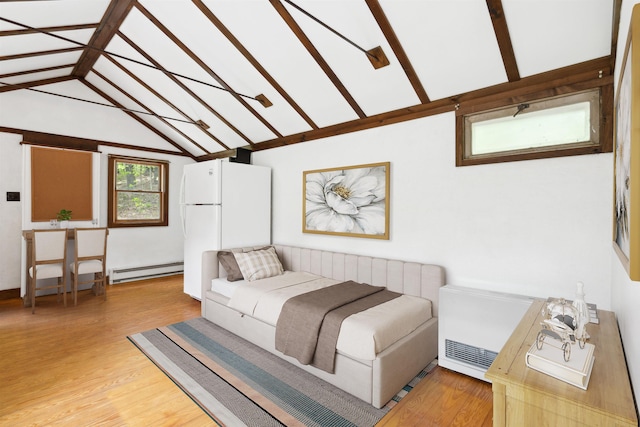 1176 Cross Rd, Strafford, VT 05070 - bedroom with baseboard heating, lofted ceiling, light wood finished floors, and freestanding refrigerator