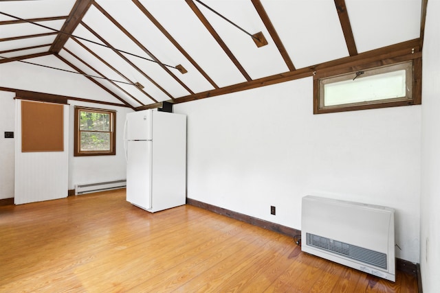 1176 Cross Rd, Strafford, VT 05070 - unfurnished room with baseboard heating, heating unit, and light wood-style floors