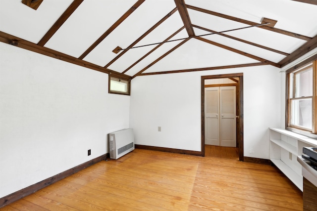 1176 Cross Rd, Strafford, VT 05070 - unfurnished living room featuring heating unit, light wood finished floors, vaulted ceiling, and baseboards