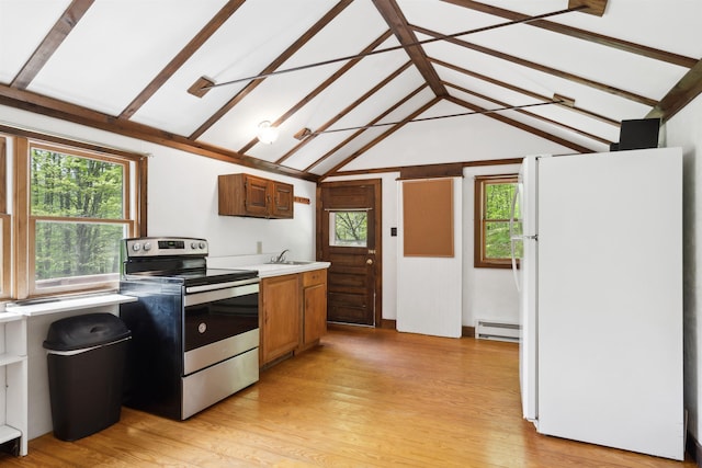 1176 Cross Rd, Strafford, VT 05070 - kitchen with freestanding refrigerator, stainless steel range with electric cooktop, a baseboard heating unit, a sink, and light wood finished floors