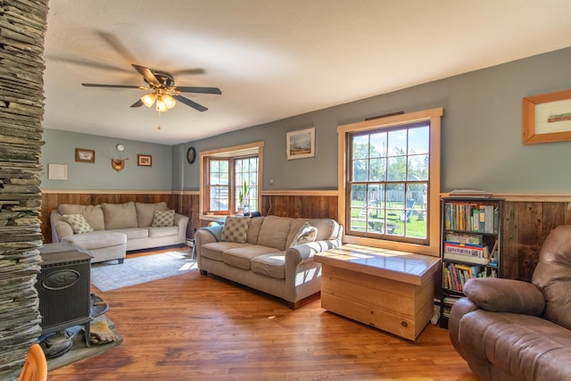 174 Andrews Rd, Holland, VT 05830 - living area featuring a wainscoted wall, a ceiling fan, wood walls, and wood finished floors