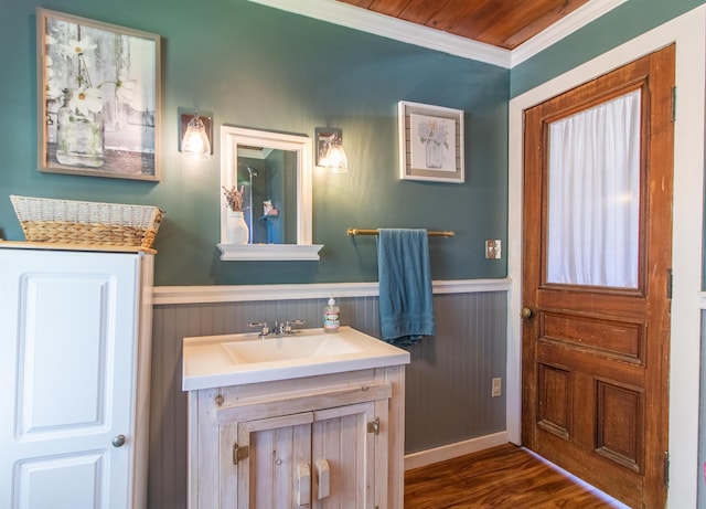 174 Andrews Rd, Holland, VT 05830 - bathroom featuring wainscoting, ornamental molding, vanity, and wood finished floors