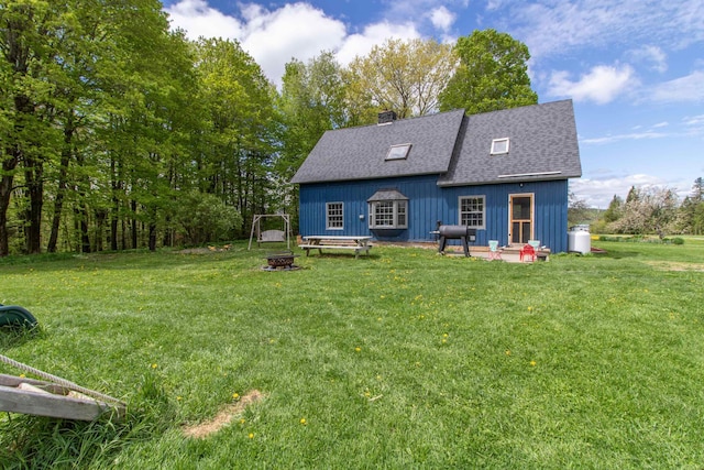 174 Andrews Rd, Holland, VT 05830 - rear view of house featuring roof with shingles, a chimney, a yard, and an outdoor fire pit