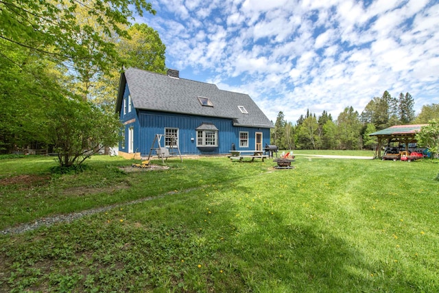 174 Andrews Rd, Holland, VT 05830 - back of house with a yard, a chimney, and roof with shingles