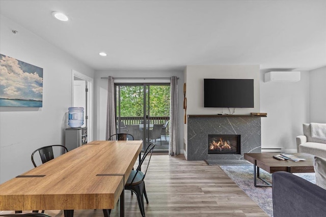 109 Mountainside Dr Unit G202, Stowe, VT 05672 - dining room featuring a wall unit AC, wood finished floors, a fireplace, a baseboard heating unit, and recessed lighting