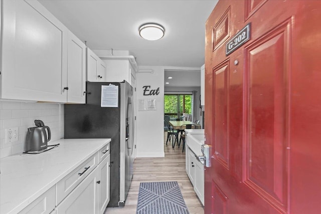 109 Mountainside Dr Unit G202, Stowe, VT 05672 - kitchen with backsplash, stainless steel refrigerator with ice dispenser, and white cabinets