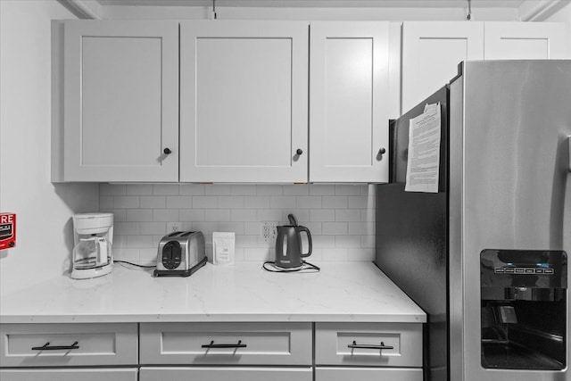 109 Mountainside Dr Unit G202, Stowe, VT 05672 - kitchen with stainless steel fridge with ice dispenser, tasteful backsplash, light stone counters, and white cabinets