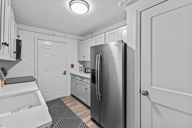 109 Mountainside Dr Unit G202, Stowe, VT 05672 - kitchen with stainless steel refrigerator with ice dispenser, light wood-style flooring, white cabinets, and stove