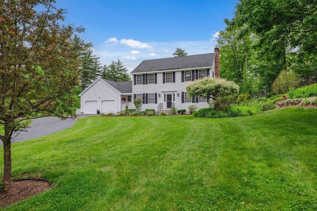 2 Cortland Rd, Milford, NH 03055 - colonial house featuring an attached garage, a chimney, driveway, and a front lawn