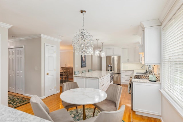 2 Cortland Rd, Milford, NH 03055 - kitchen with high end refrigerator, a chandelier, a center island, a sink, and light wood-type flooring