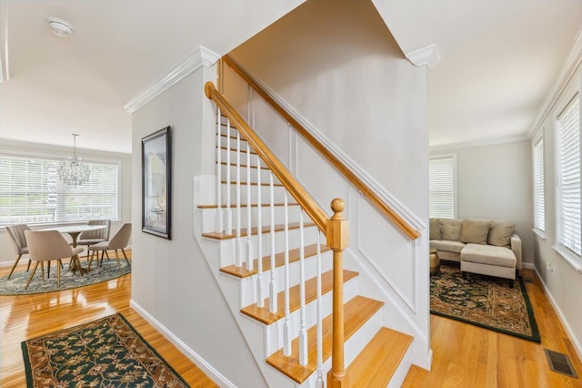 2 Cortland Rd, Milford, NH 03055 - stairs with wood finished floors, a chandelier, ornamental molding, and baseboards