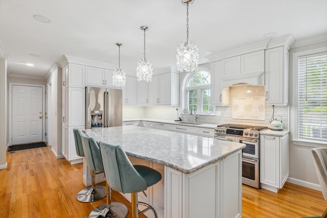 2 Cortland Rd, Milford, NH 03055 - kitchen with premium appliances, a chandelier, light wood-style floors, a sink, and a center island