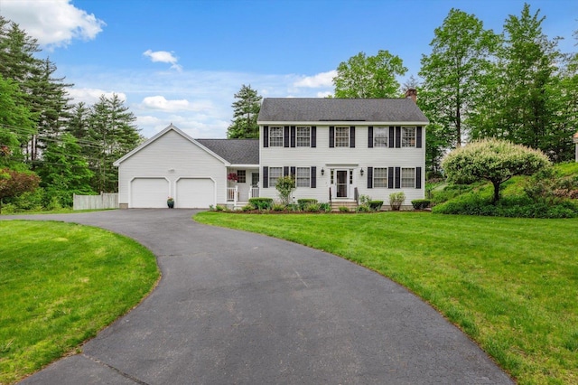 2 Cortland Rd, Milford, NH 03055 - colonial-style house featuring an attached garage, a chimney, a front yard, driveway, and roof with shingles