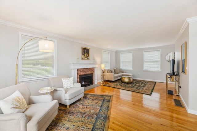 2 Cortland Rd, Milford, NH 03055 - living room featuring light wood-style floors, healthy amount of natural light, crown molding, and a brick fireplace