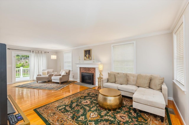 2 Cortland Rd, Milford, NH 03055 - living area featuring wood finished floors, ornamental molding, a fireplace, and baseboards