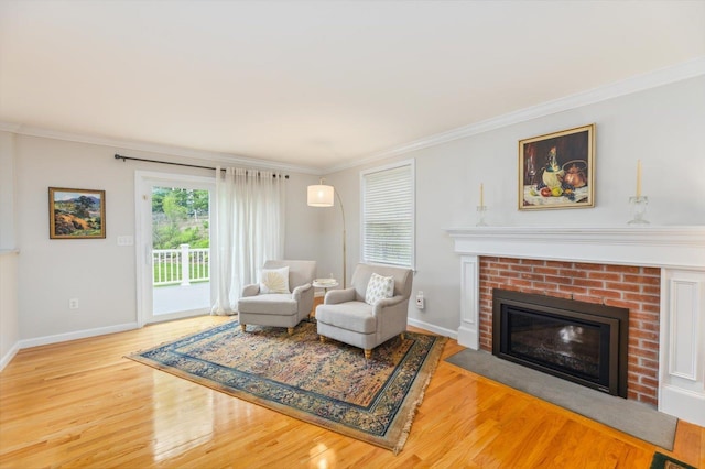 2 Cortland Rd, Milford, NH 03055 - living area with wood finished floors, a brick fireplace, baseboards, and crown molding