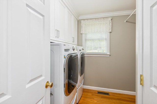 2 Cortland Rd, Milford, NH 03055 - laundry room featuring washer and clothes dryer, light wood-style floors, baseboards, crown molding, and cabinet space