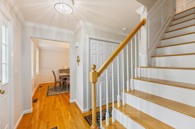 2 Cortland Rd, Milford, NH 03055 - foyer entrance featuring stairway, a chandelier, wood finished floors, crown molding, and wainscoting