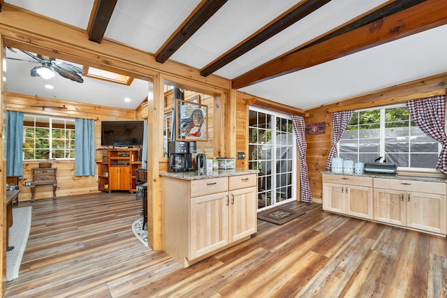 18 Mayflower Ln, Moultonborough, NH 03254 - kitchen with light wood-style flooring, wood walls, light brown cabinetry, and plenty of natural light