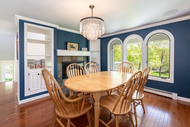 21 Hawk Ridge Rd, Meredith, NH 03253 - dining area with a chandelier, a fireplace, baseboards, hardwood / wood-style flooring, and built in features