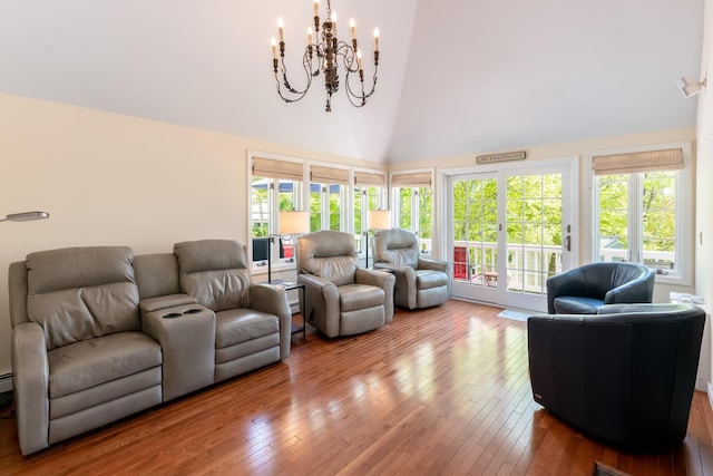 21 Hawk Ridge Rd, Meredith, NH 03253 - living area featuring a chandelier, hardwood / wood-style floors, and high vaulted ceiling