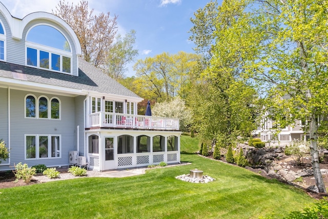 21 Hawk Ridge Rd, Meredith, NH 03253 - back of house featuring a lawn, roof with shingles, a balcony, and ac unit